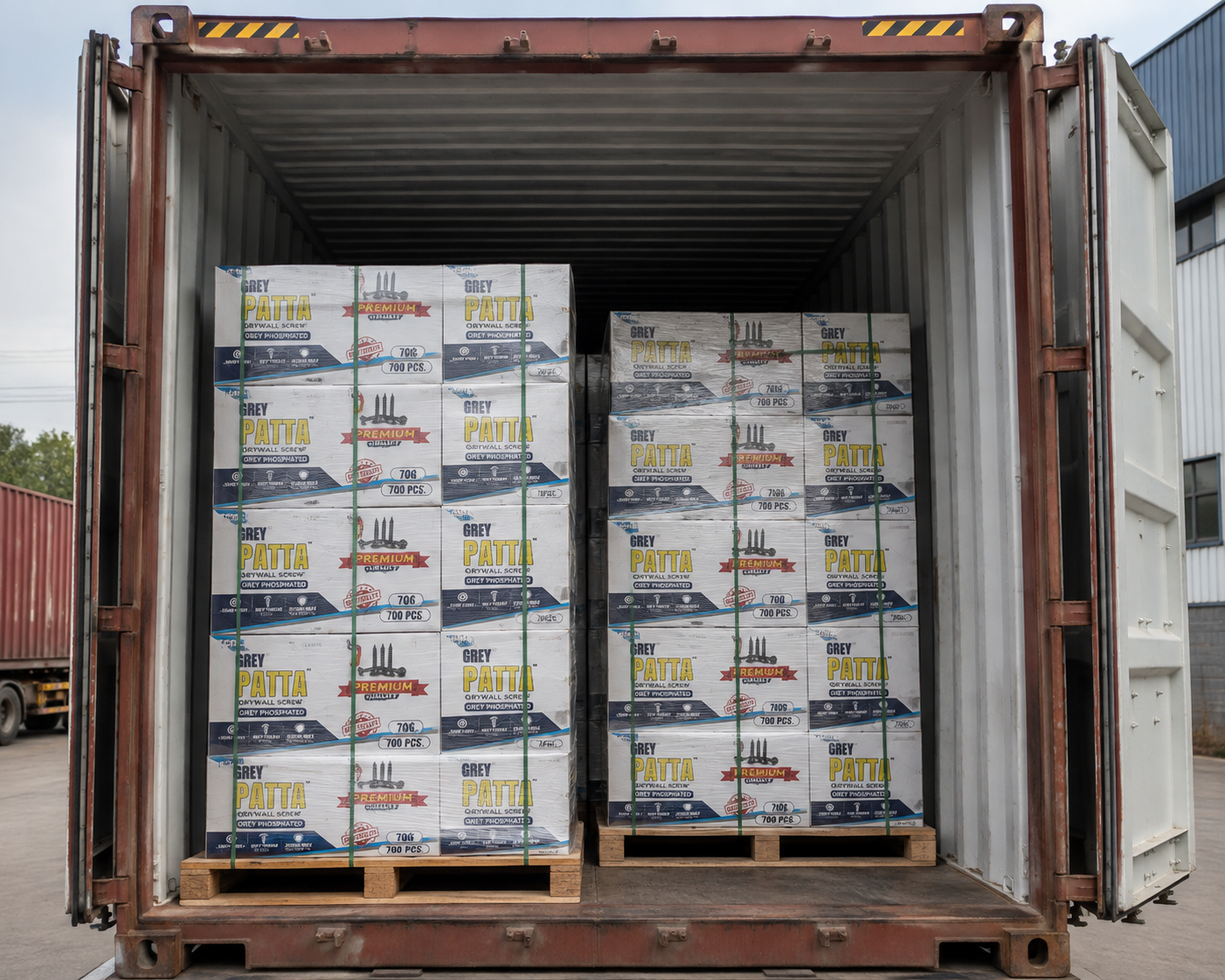 Grey Patta cartons loaded on pallets inside a shipping container